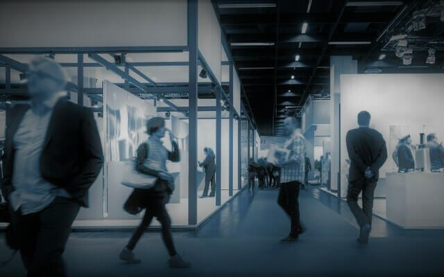 Staff walking through the halls of a modern office with glass walls.