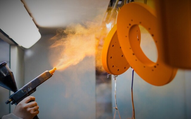 Spraying steel parts with corrosion inhibitor.