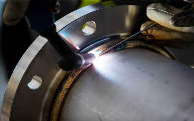 Welding a pipe to a flange.