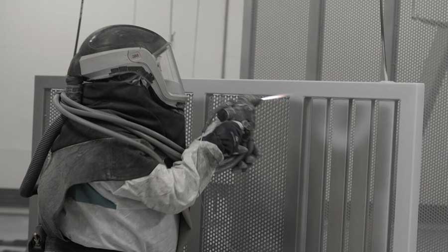 Worker drilling a piece of metal.