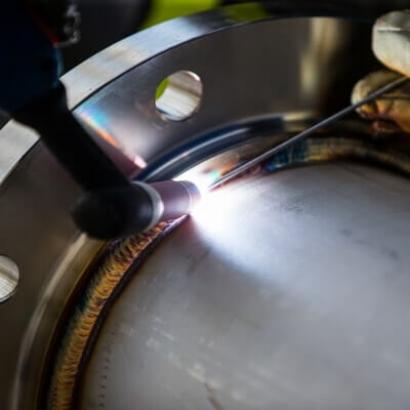 Welding a pipe to a flange.